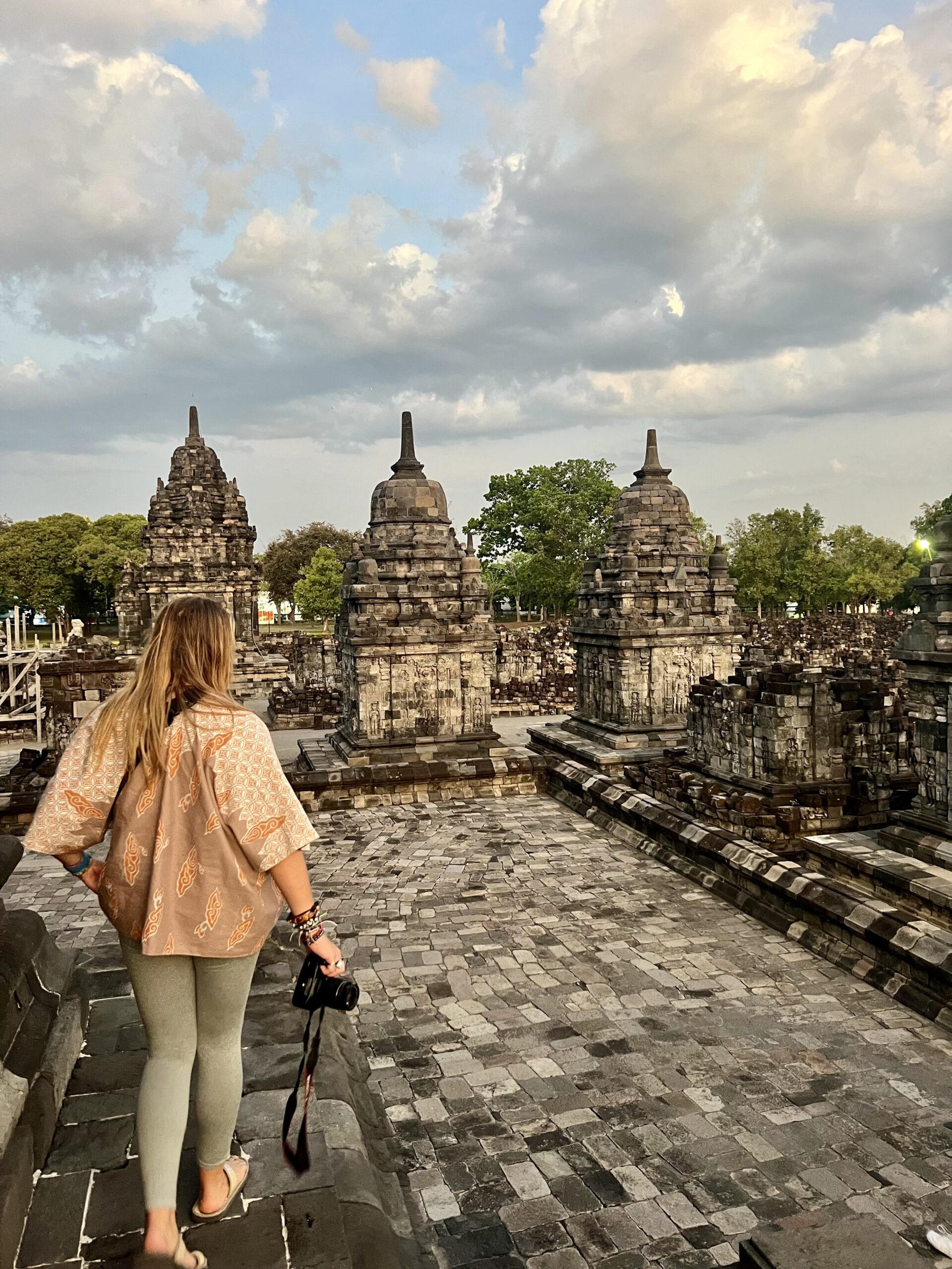 Prambanan Temple in Indonesia at sunset, showcasing intricate Hindu architecture and rich cultural heritage—perfect for a culture travel blog exploring historical landmarks and Southeast Asian history; rambling adventurista