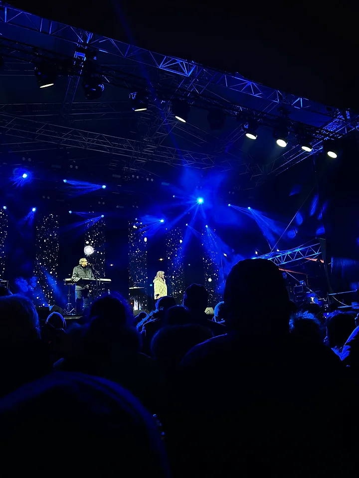 Vibrant New Year's Eve celebration in the picturesque streets of Tallinn, Estonia, with fireworks lighting up the night sky.