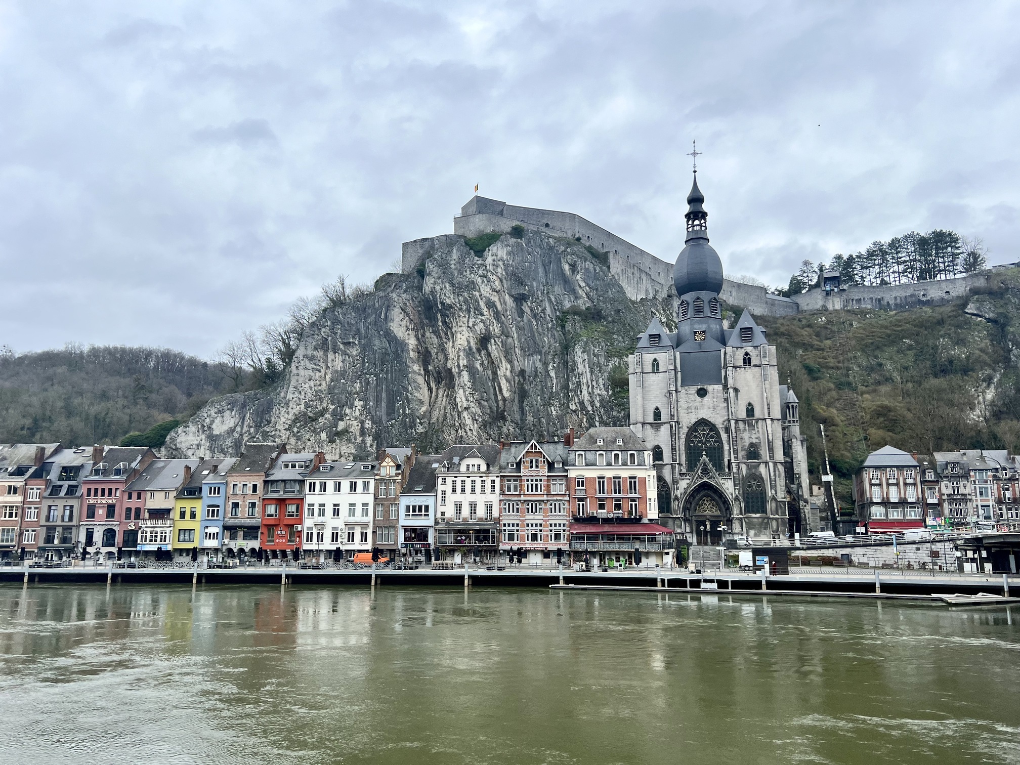 Enchanting view in Dinant, Belgium, with ornate medieval architecture and bustling activity, capturing the essence of Belgian heritage and culture.; travel guide to Dinant