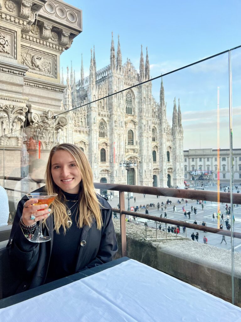 Panoramic view of Milan, Italy showcasing the iconic Milan Cathedral (Duomo di Milano) with its intricate Gothic architecture, bustling Piazza del Duomo, and vibrant cityscape under a clear blue sky. The historic Galleria Vittorio Emanuele II and modern skyscrapers in the background highlight Milan's blend of traditional and contemporary charm, making it a top travel destination for culture, fashion, and architecture enthusiasts; travel guide to Italy