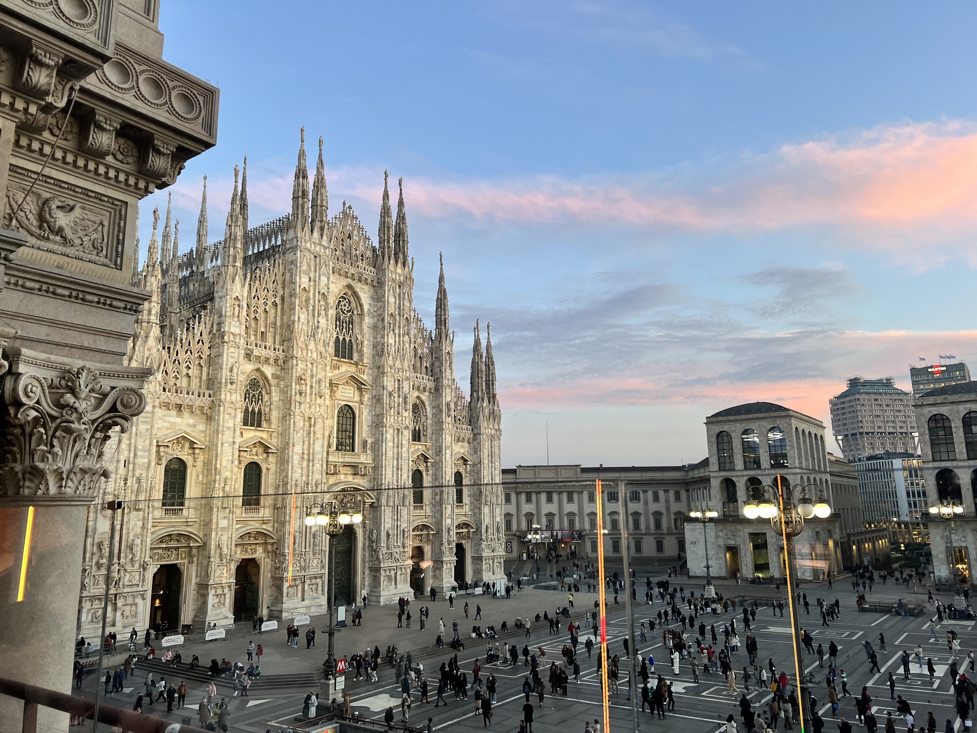 Panoramic view of Milan, Italy showcasing the iconic Milan Cathedral (Duomo di Milano) with its intricate Gothic architecture, bustling Piazza del Duomo, and vibrant cityscape under a clear blue sky. The historic Galleria Vittorio Emanuele II and modern skyscrapers in the background highlight Milan's blend of traditional and contemporary charm, making it a top travel destination for culture, fashion, and architecture enthusiasts. Authentic Italian Souvenirs: What souvenirs to buy in Italy