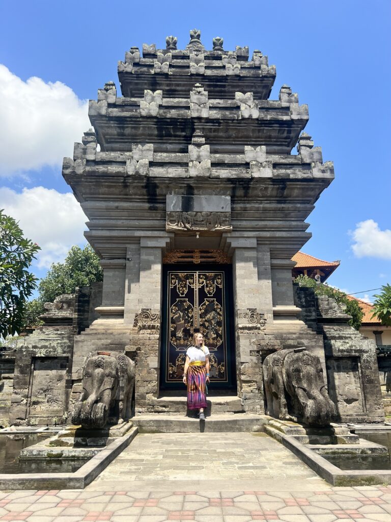 Scenic view of Indonesia featuring lush green rice terraces, a towering volcano in the distance, and vibrant tropical flora, showcasing the natural beauty and cultural richness of Southeast Asia's largest archipelago. Perfect for travel inspiration, adventure tourism, and exploring Indonesia's unique landscapes; best places to visit in Bali