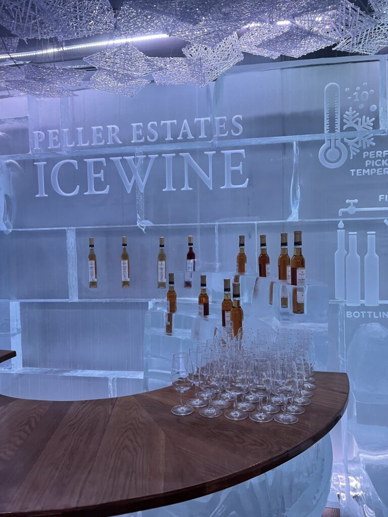 Scenic vineyard in Niagara-on-the-Lake, Canada, showcasing rows of lush grapevines under a bright summer sky—renowned wine region famous for icewine and wine tasting tours near Lake Ontario; Canadian souvenirs