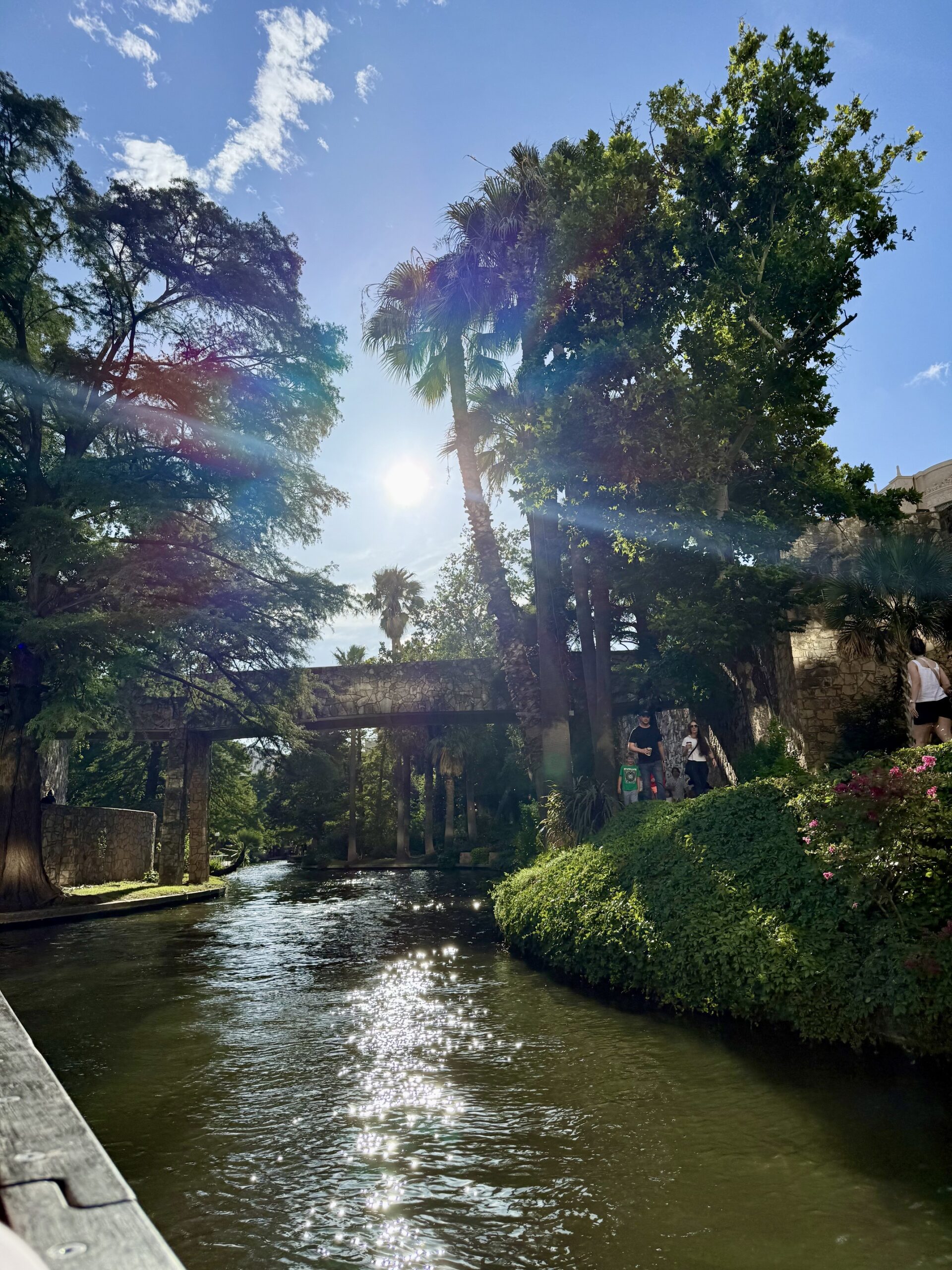 Scenic view of San Antonio River Walk in downtown San Antonio, Texas, featuring vibrant restaurants, historic architecture, and lush greenery — a top travel destination known for the Alamo, Tex-Mex cuisine, and cultural attractions; travel guide to Texas
