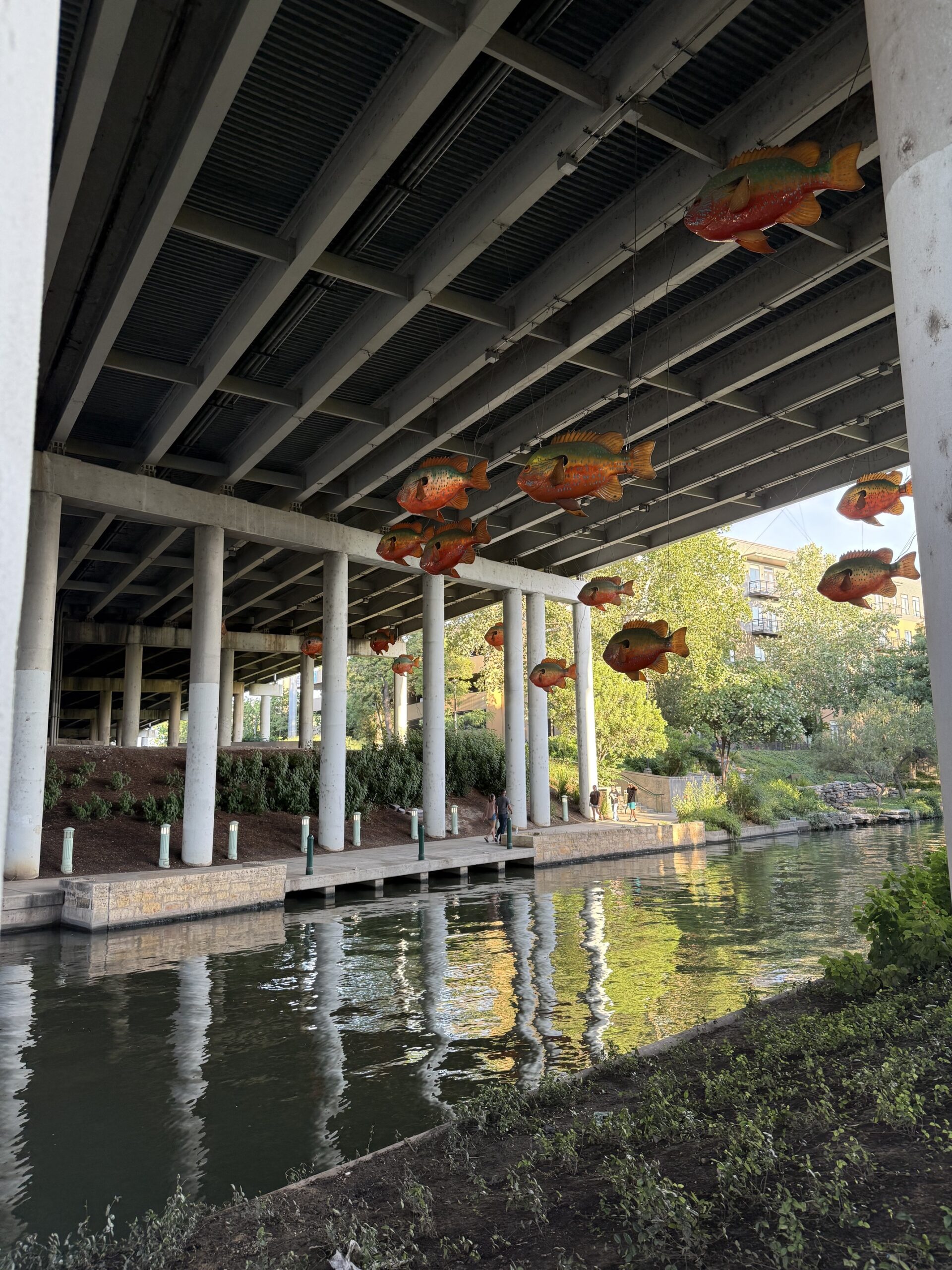 Scenic view of San Antonio River Walk in downtown San Antonio, Texas, featuring vibrant restaurants, historic architecture, and lush greenery — a top travel destination known for the Alamo, Tex-Mex cuisine, and cultural attractions; travel guide to San Antonio
