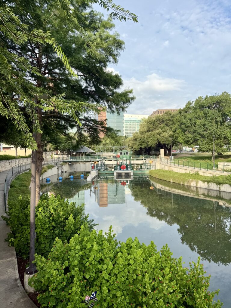 Scenic view of San Antonio River Walk in downtown San Antonio, Texas, featuring vibrant restaurants, historic architecture, and lush greenery — a top travel destination known for the Alamo, Tex-Mex cuisine, and cultural attractions; best places to visit in Texas