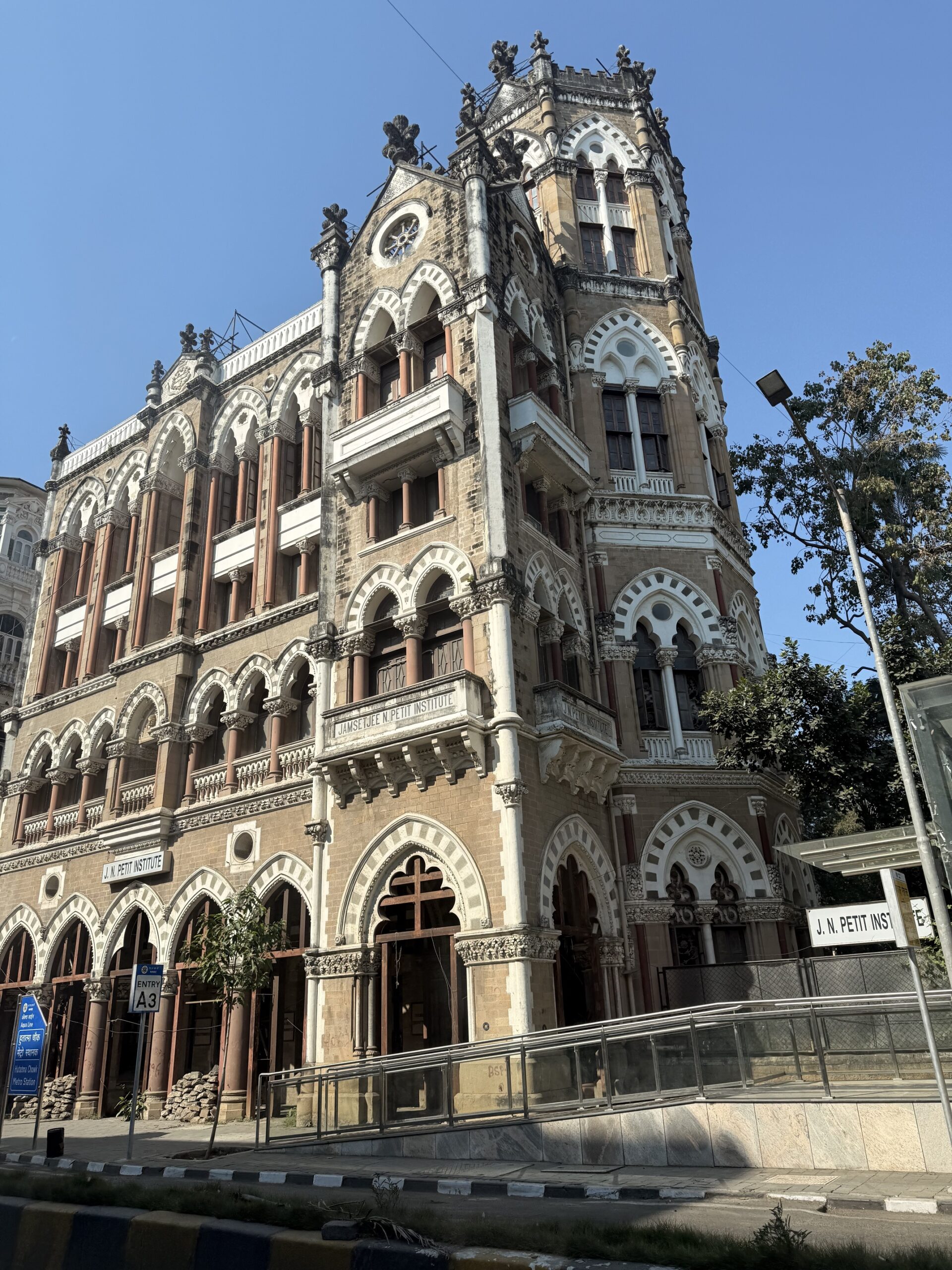 Busy street scene in Mumbai with tuk-tuks taxis and pedestrians