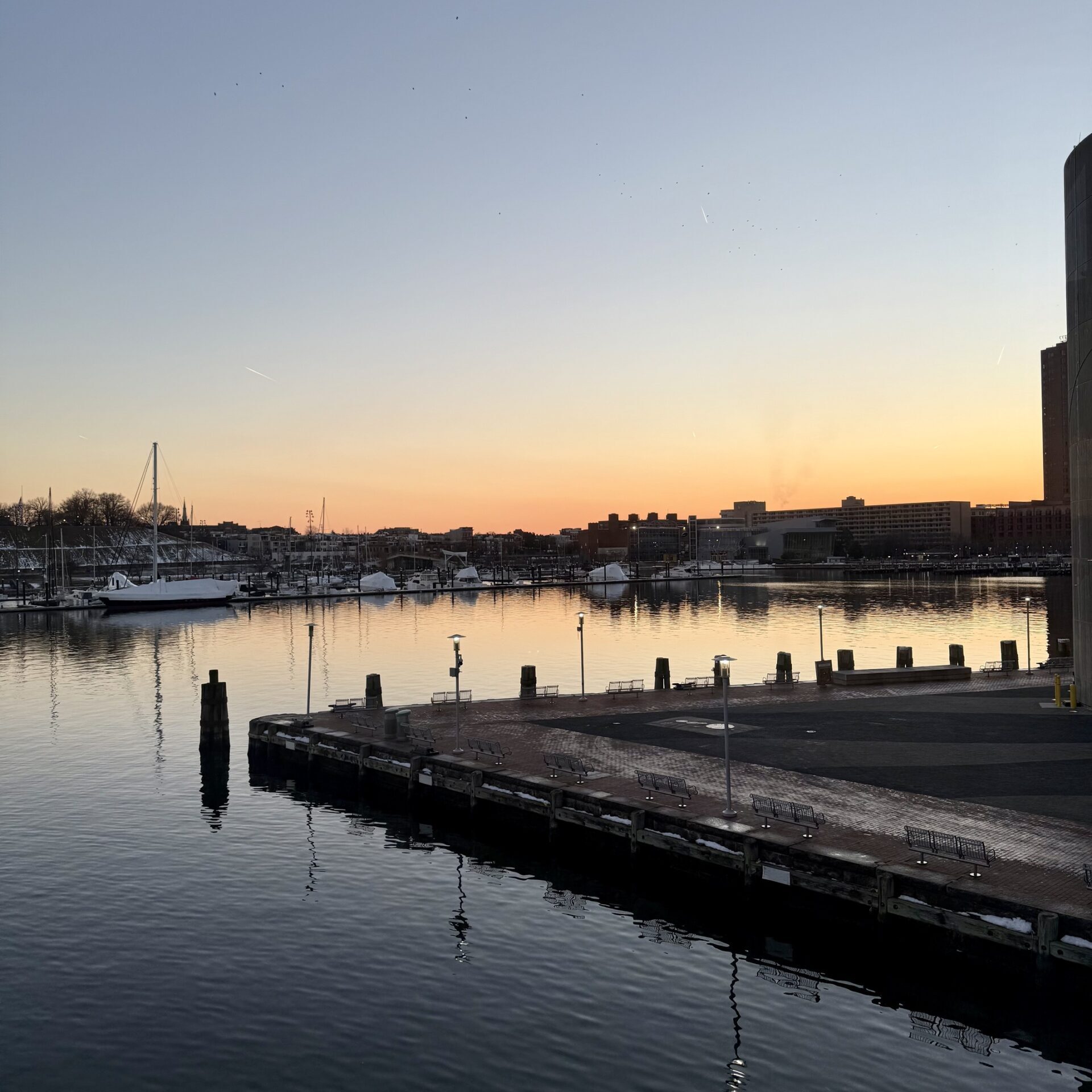 Skyline of Baltimore, Maryland at dusk showcasing the iconic Inner Harbor, modern skyscrapers, and historic architecture. A stunning view of the city with vibrant waterfront reflections and cultural landmarks, highlighting Baltimore as a hub of history, tourism, and urban charm.