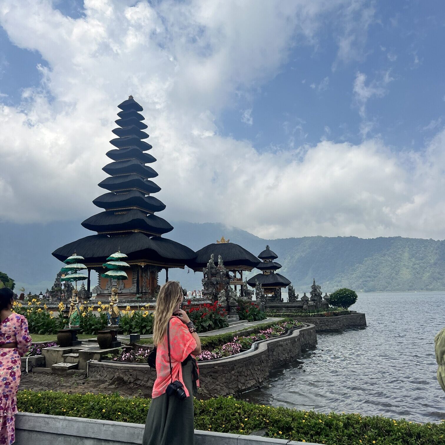 Scenic view of Indonesia featuring lush green rice terraces, a towering volcano in the distance, and vibrant tropical flora, showcasing the natural beauty and cultural richness of Southeast Asia's largest archipelago. Perfect for travel inspiration, adventure tourism, and exploring Indonesia's unique landscapes; travel guide to Ubud