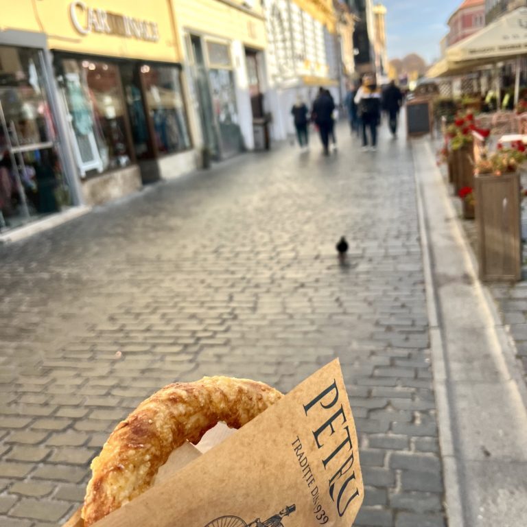 Delicious Covrigi pastries in Brașov - Traditional Romanian pretzels with a golden crust, served fresh and warm, representing the culinary delights of Brasov's local cuisine.